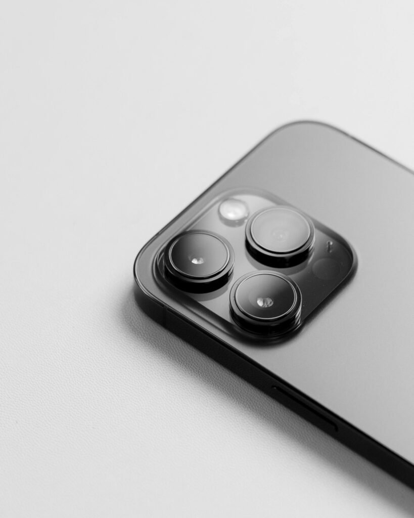 pexels-photo-17177820-17177820 Close-up of a modern smartphone camera. High-quality lens detail on a white background.